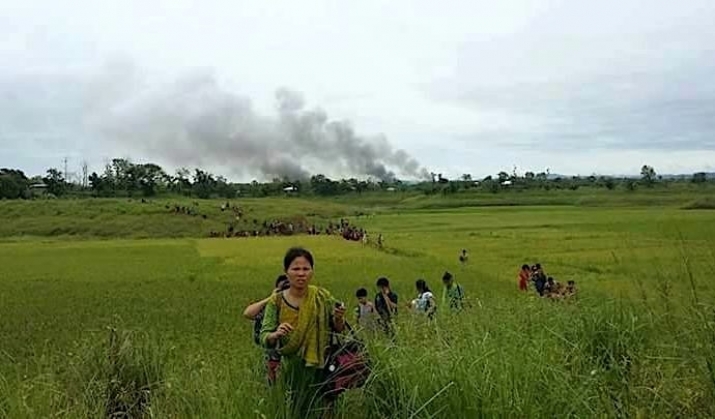 Indigenous people flee attacks by Bengali Muslim settlers in Longadu on 2 June as smoke rises from their burning homes. From facebook.com