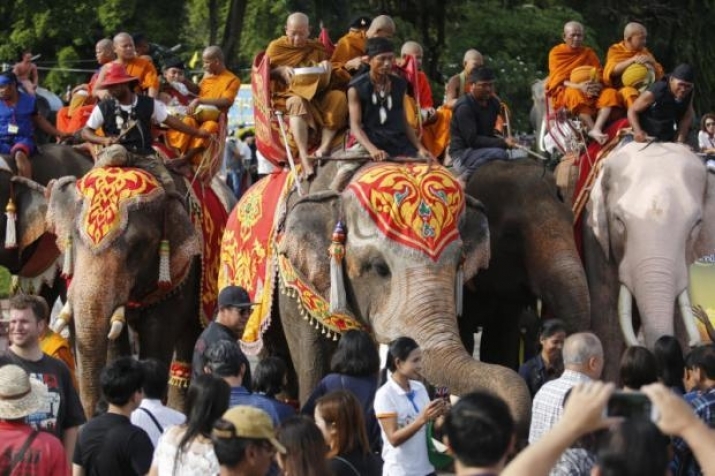 Monks make a special morning alms round on elephant back during a ceremony in Surin Province. From bangkokpost.comjpg