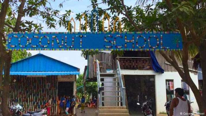 The school gate, decorated with used plastic spoons and bottle caps. From dw.com