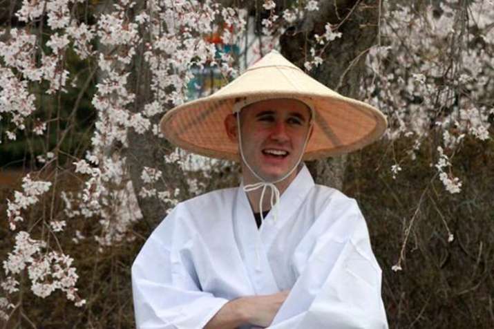 Kristopher Littlefield in his pilgrim outfit: a white robe (<i>hakue</i>) and conical hat (<i>suge-gasa</i>). Image courtesy of Kristopher Littlefield