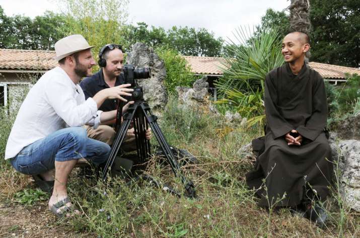 Filmmakers Marc J Francis, left, and Max Pugh, right on location at the Plum Village Monastery in France. Photo by Anne-Sophie Mauffre. Image courtesy of UA CineHub