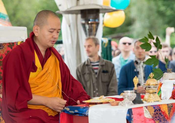 Venerable Kundeling Tatsak Rinpoche conducts the consecration ceremony for the stupa. Image courtesy of Sergei Chernyshev