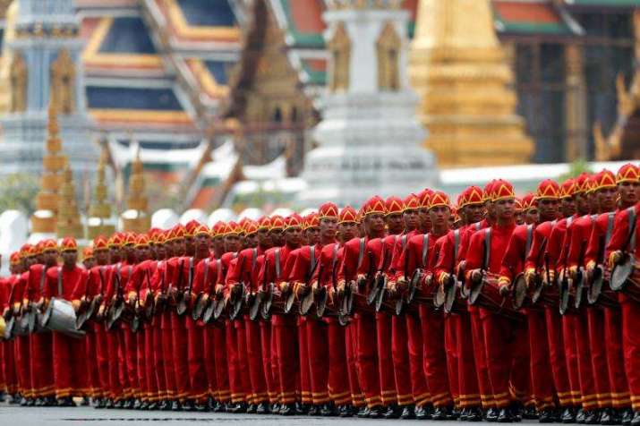 Ceremonial drummers accompany the royal cremation procession. From reuters.com