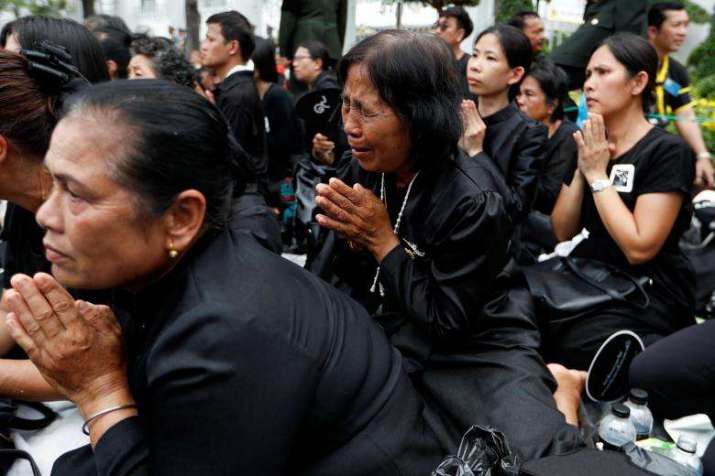 Weeping for the late king, mourners prostrate before the royal funeral procession. From reuters.com