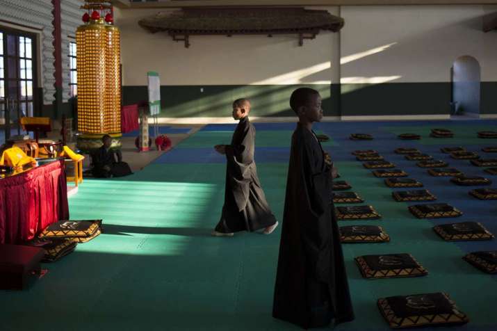 A Buddhist service is held each morning and evening,. From aljazeera.com