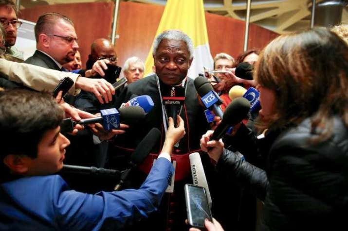 Cardinal Peter Turkson talks with reporters during the conference. Photo by Tony Gentile. From reuters.com