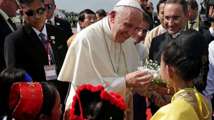 Pope Francis receives flowers after landing in Yangon. From aljazeera.com