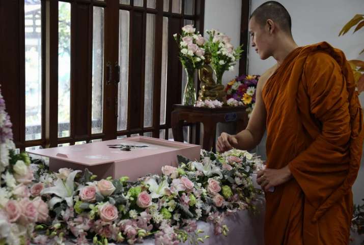 A Buddhist monk looks at the funeral casket of a pet. From japantimes.co.jp