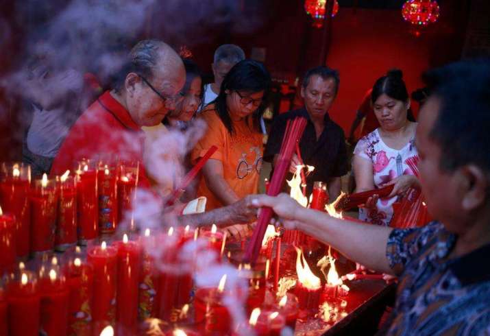 Ethnic Chinese in Indonesia light incense sticks during celebrations at a temple in Jakarta. From trtwold.com