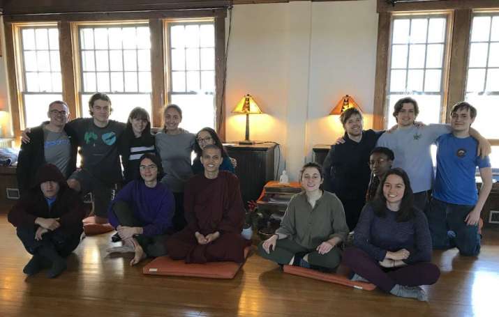Rev. McGonigle, back row left, with Ven. Priyarakkhit Sraman, Buddhist in Residence at Tufts, front row center, with the Tufts Mindfulness Buddhist Sangha. Image courtesy of Tufts University Chaplaincy