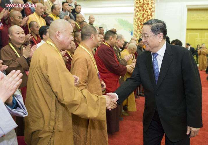 Yu Zhengsheng, chairman of the National Committee of the Chinese People’s Political Consultative Conference, shakes hands with representatives of the Buddhist Association of China in Beijing, 21 April 2015. From xinhuanet.com