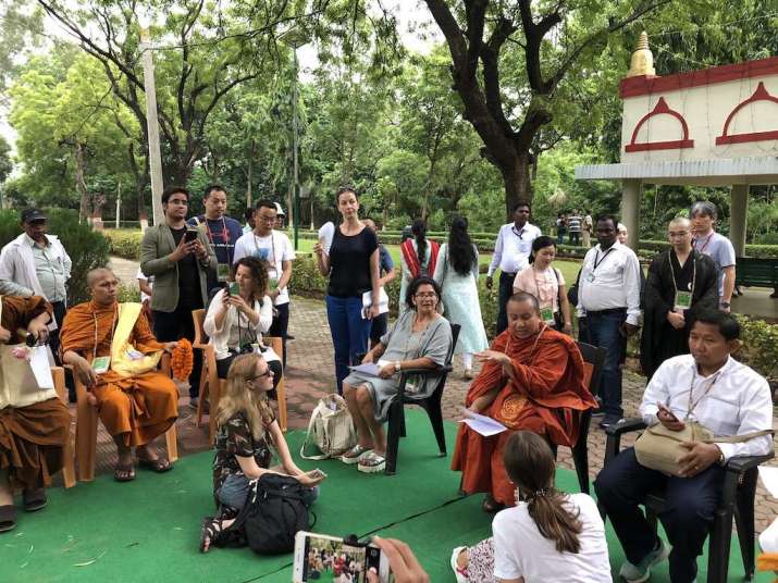 Ven. Sovanaratana talks to delegates about the history of the Bamboo Grove, Rajgir, on 26 August. Image courtesy of the author