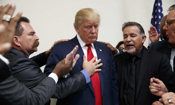 Pastors from Nevada pray with Donald Trump during a visit to Las Vegas in October 2016. From theguardian.com