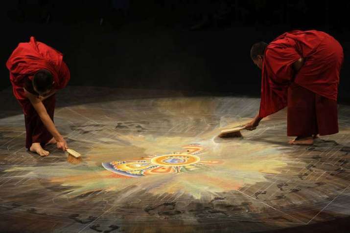Monks destroy a mandala. From newmandala.org