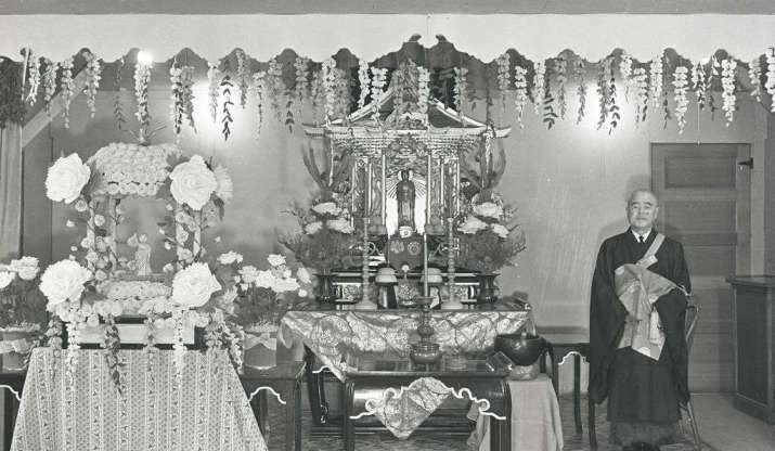 Japanese American Rinban Kankai Izuhara at the altar of the Buddhist church at Heart Mountain. From smithsonianmag.com