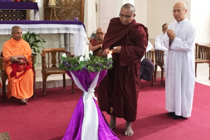 Myawaddy Sayadaw lights a candle at an interfaith gathering at the Sacred Heart Cathedral in Mandalay in 2016. From ucanews.com