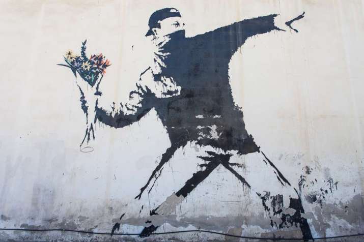<i>Rage, the Flower Thrower</i> by Banksy, Jerusalem. From the8percent.com