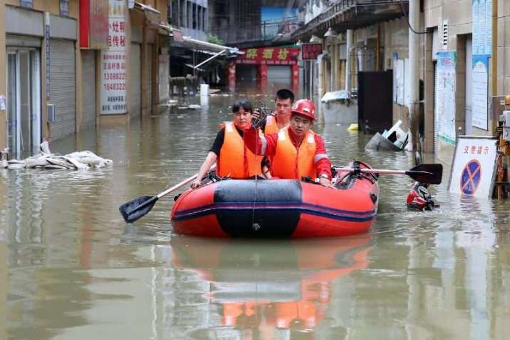 Rescuers use an inflatable boat to save residents in Neijiang, Sichuan. From irishexaminer.com