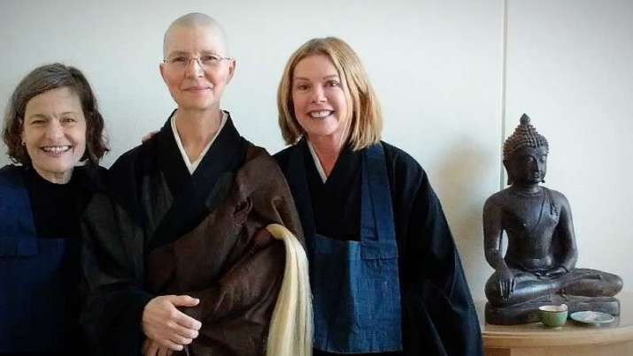 End of the Jukai ceremony, giving the 16 precepts to student Dana Elliott, left, attended by Norma Fogelberg, right, at the Insight Meditation Center in Redwood City, California. Image courtesy of Martha Chickering