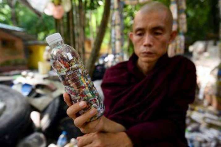 Sayadaw U Ottamasara holds a PET bottle filled with discarded plastic bags at Thabarwa Centre. Photo by Shew Paw Mya Tin. From swissinfo.ch