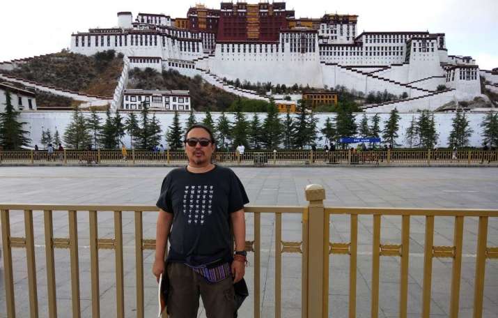 Mitruev in front of Potala Palace, Tibet, 2017. Image courtesy of Bem Mitruev