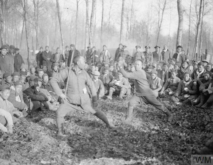 This amazing photograph from Europe during World War One shows Chinese laborers who worked for the Allied war effort in 1918. They stayed in camps set up by the YMCA. Two workers in this camp practice their Shaolin martial arts. These workers also brought their ritual robes and masks, and even performed simple versions of popular operas. Image courtesy of Angry Baby Books, copyright IWM