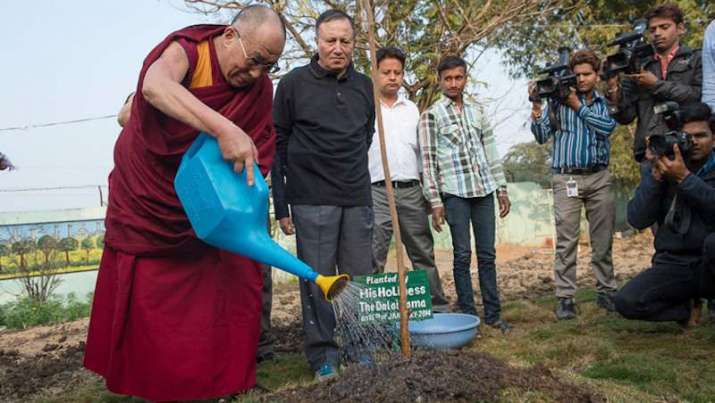 His Holiness the Dalai Lama planting a sapling. From phayul.com