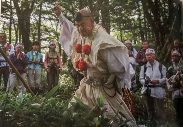 Purification ritual along the trail, walking with members of the public. Photo by Takeshi Mori