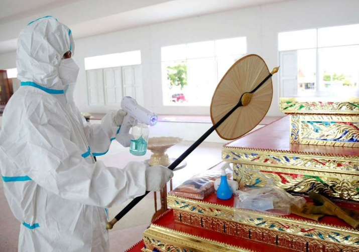 Disinfecting monastic ritual implements prior to cremating the body of a COVID-19 victim. From reuters.com