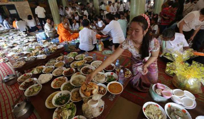 Lay Buddhists offer food to their ancestors during Pchum Ben. From khmertimeskh.com