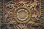 Cave 10: A large lotus medaillon with eight flying celestials whirling around. This carving is on the top of the window.