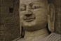 Cave 20, Originally the huge figure was not exposed but concealed behind a front wall which probably collapsed before the Liao Dynasty. The main figure is 14 metres high and seated in the dhyana, a meditating position. The proportions of the figure are ex