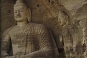 Cave 20, Originally the huge figure was not exposed but concealed behind a front wall which probably collapsed before the Liao Dynasty. The main figure is 14 metres high and seated in the dhyana, a meditating position. The proportions of the figure are ex