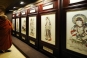 A delegate looks at a porcelain exhibition on Chinese Buddhism during the Second World Buddhist Forum (WBF) in Wuxi, east China's Jiangsu Province, on March 29, 2009. (Xinhua/Han Yuqing)