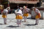 Dressed in colourful bright brocades with vibrantly decorated and richly adorned paper mache or copper-gilded masks (some extending over 1 metre in height) the masked dancers simulate combat between good spirits and evil demons.